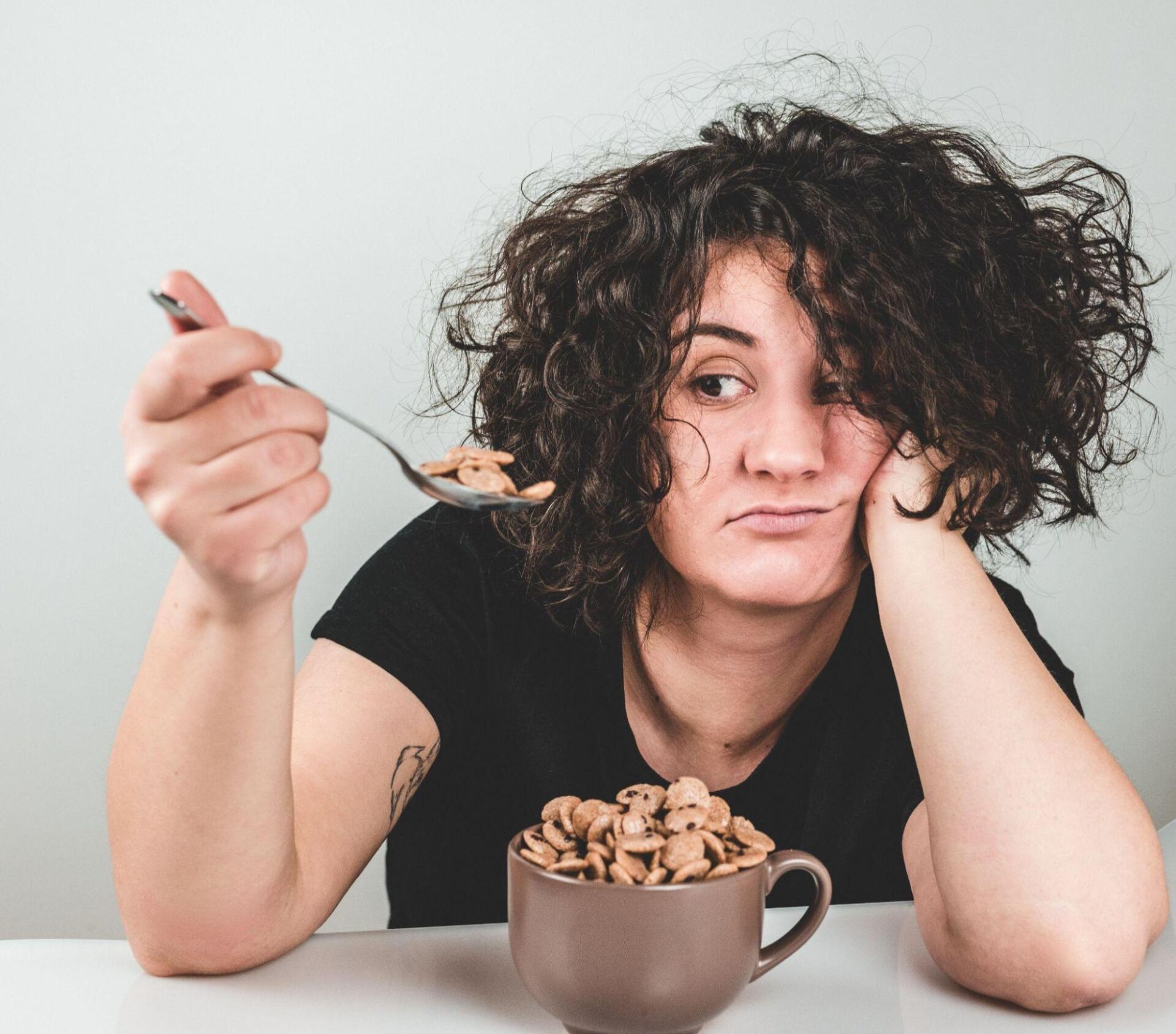 Person with weight and eating disorder deciding whether or not to eat cereal