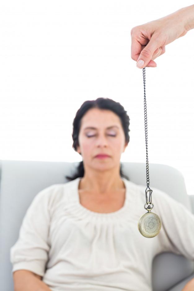 Woman being hypnotized through a pendulum watch