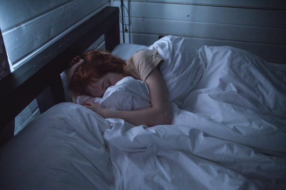 A woman struggling with sleep disorders finds it difficult to rest fully.